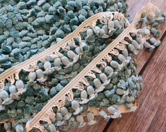 May include: Two pieces of blue and white trim with tassels. The trim is made of a soft, fuzzy material and has a delicate, feminine look.