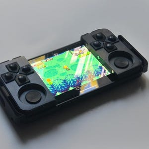 Bediening van de telefoon met tactiele emulateur pour jeux rétro