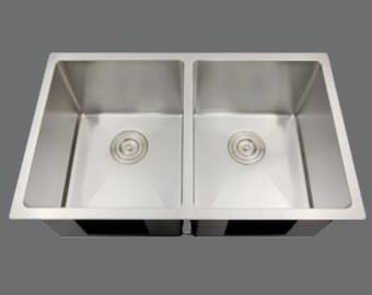 May include: A stainless steel double kitchen sink with two bowls. Each bowl has a single drain.