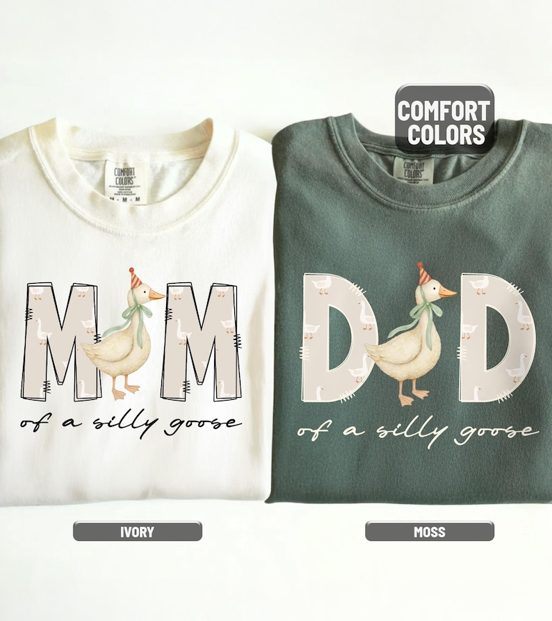 May include: Ivory and moss green crewneck sweatshirts. The ivory sweatshirt says "MOM of a silly goose" with a goose graphic. The moss green sweatshirt says "DAD of a silly goose" with a goose graphic. Both have the words "COMFORT COLORS" on them.