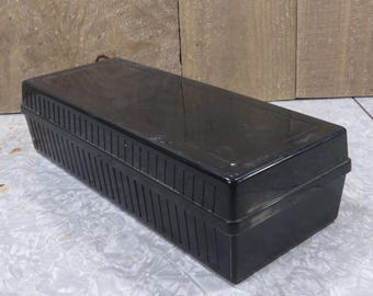 May include: A black plastic storage box with a ribbed design. The box is rectangular and has a lid.