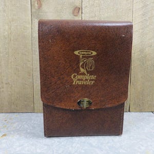 May include: A brown leather travel case with a gold logo that says "Osrow Complete Traveler".
