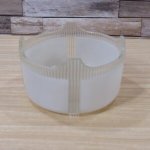 May include: White frosted glass bowl with a decorative ribbed design. The bowl has a round shape and a wide opening.