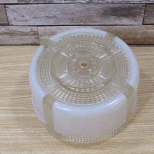 May include: White frosted glass ceiling light fixture with a clear glass top and a decorative pattern.