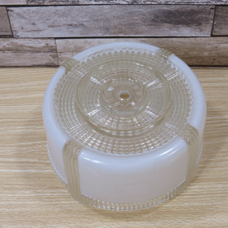 May include: White frosted glass ceiling light fixture with a clear glass top and a decorative pattern.