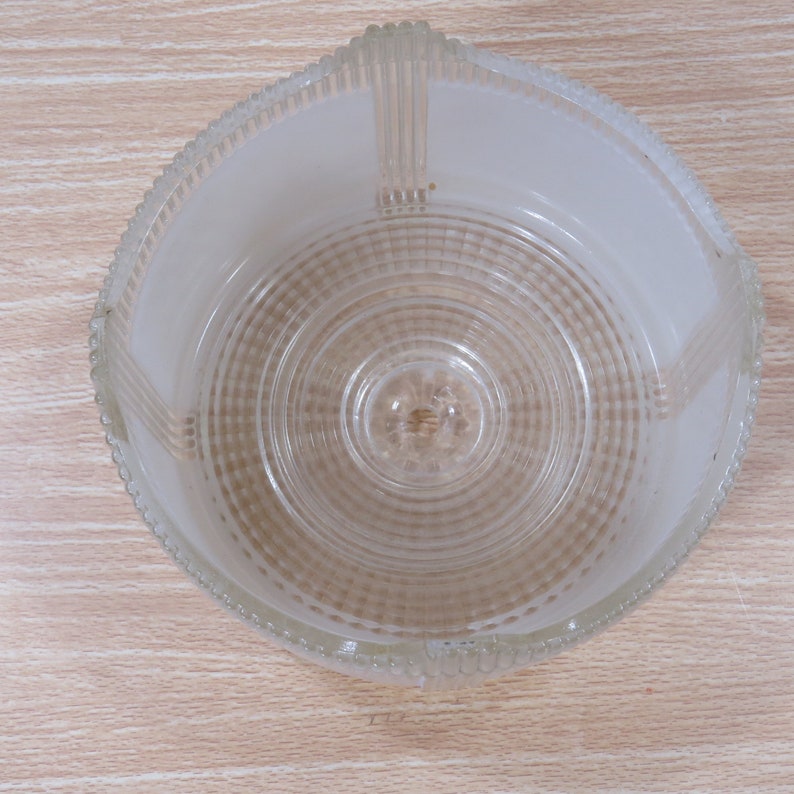 May include: A clear glass lampshade with a frosted white interior and a textured, ribbed design.