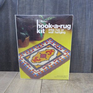 May include: A Malina hook-a-rug kit with a colorful rug design. The kit includes yarn and instructions to create a rug or wall hanging. The finished rug size is approximately 24 inches by 27 inches. Style #25-24 SIROCCO.