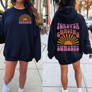 May include: Two black sweatshirts with a sunset graphic and the text "FOREVER CHASING SUNSETS" and "SUNSETS".