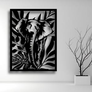 May include: Black metal wall art featuring a silhouette of an elephant's head with intricate leaf designs.