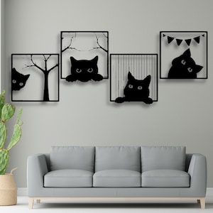 May include: Black metal wall art depicting four square frames with cat silhouettes. One frame includes a tree, another a banner, and the others cats peeking out. The art is mounted above a grey sofa.