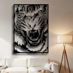 May include: Black and white metal wall art featuring a close-up of a tiger's face with an open mouth and sharp teeth.