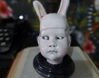 Doll head bunny ear sculpture