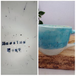 May include: A ceramic mug with a turquoise and white glaze. The mug has a handle and a speckled finish. The words "Massive Cunt" are written on the inside of the mug.