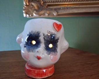 doll head  tea light holder with tea light