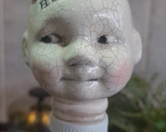 Ceramic doll head bah humbug christmas bottle stopper