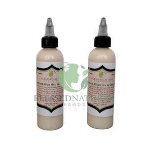 May include: Two 4 oz bottles of Blessed Natural Hair Products Fermented Rice Hair & Skin Serum. The bottles are white with black caps and labels. The labels are white with black text and a green leaf logo.