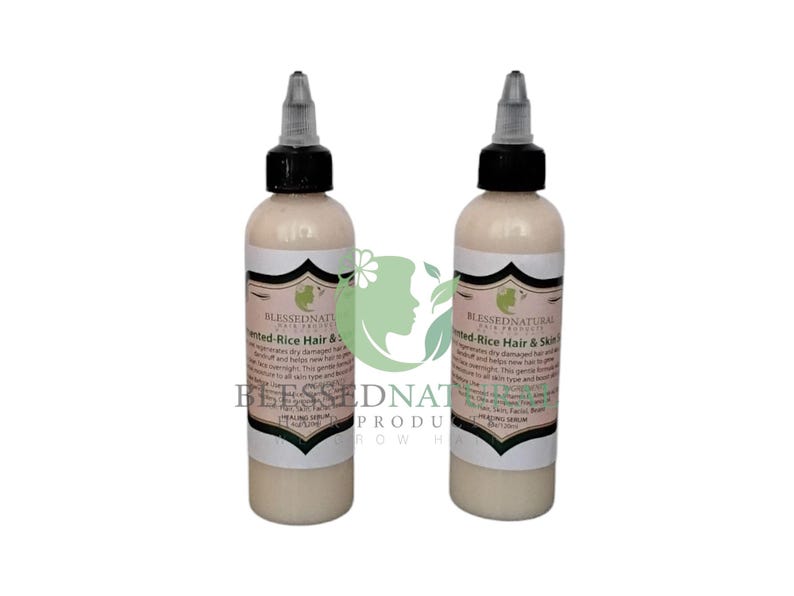 May include: Two 4 oz bottles of Blessed Natural Hair Products Fermented Rice Hair & Skin Serum. The bottles are white with black caps and labels. The labels are white with black text and a green leaf logo.