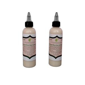 May include: Two 4 oz bottles of Fermented Rice Hair & Skin Serum by Blessed Natural Hair Products. The bottles are clear with a white liquid inside and black caps with a white tip.