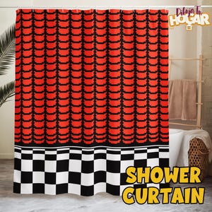 May include: A red and black patterned shower curtain with a checkerboard design at the bottom. The words "SHOWER CURTAIN" are in yellow text on the bottom right. The curtain is hanging in a bathroom.