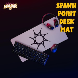 May include: A white desk mat with a black sunburst design, a black keyboard, a mouse, and a headset. The words "SPAWN POINT DESK MAT" are in yellow block letters. The logo "Delicias Tu Hogar" is in the upper left corner.