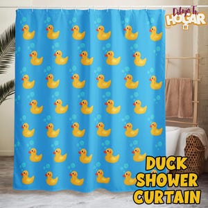 May include: A blue shower curtain featuring a pattern of yellow cartoon ducks and bubbles. The words "DIBUJA TU HOGAR" are at the top, and "DUCK SHOWER CURTAIN" is at the bottom in yellow and orange text.