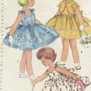May include: Vintage sewing pattern illustration featuring three children's dresses. The dresses are in blue, yellow, and white with floral patterns. The text "Child Size 4" is visible at the top of the image.