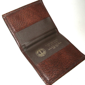 May include: A brown leather wallet with a gold embossed logo and the text "75 Year Club Ladies 75th Anniversary of Local 1222 Indiana Harbor Workers 1901 - 1977".
