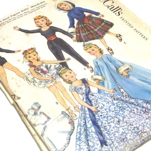 May include: A vintage paper doll pattern booklet with the title "Callis Printed Pattern 223" and the text "High Fashion Dolls' Wardrobe" on the cover. The booklet features five paper dolls with different outfits, including a ballerina, a princess, and a woman in a plaid skirt.