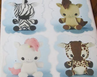 May include: A sewing pattern for making four stuffed animal toys: a zebra, a horse, a unicorn, and a giraffe. The pattern is from Simplicity and is for one size. The pattern is printed on a white background with a pink border.