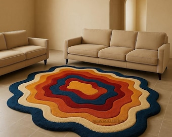 May include: A colorful, abstract rug with a wavy, layered design. The rug features concentric bands of color, including blue, orange, red, and yellow. The rug is placed on a tiled floor in a room with two sofas.