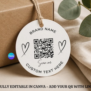 Könnte beinhalten: Ein weißes, rundes Etikett mit einem QR-Code, Herzen und dem Text "BRAND NAME" und "CUSTOM TEXT HERE". Das Etikett ist an einer braunen Schachtel mit Bindfaden befestigt. Der Text "Scan me" ist ebenfalls vorhanden.