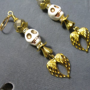 Day of the Dead/Dia de los Muertos Howlite Bone Skull Earrings with Gold Tone Angel Wings and Gold tone Faceted Bead