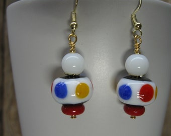 White Glass Bead with Red, Yellow, Blue and Black Accents, White Glass Bead, Red Disk and Silver Tone Findings Dangle Earrings