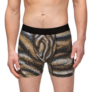 May include: Brown and black boxer shorts with a snake skin pattern.