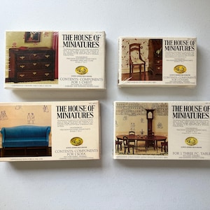 May include: Four miniature furniture kits from "The House of Miniatures." Each box features a different piece: a chest, two chairs, a sofa, and a dining table set. The boxes are cream-colored with text and images of the furniture.