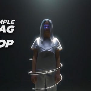 May include: A person wearing a white outfit and blue-tinted glasses stands in front of a black background. The text "A SIMPLE DRAG & DROP" is displayed in white letters on the left side of the image.