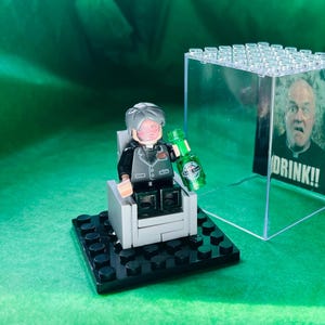 From Father Ted Irish Comedy the iconic Father Jack quote Drink in minifigure Display case