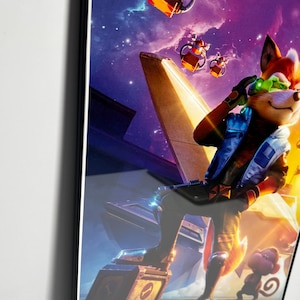 May include: Framed poster featuring a cartoon fox character in a futuristic setting with a space background. The fox is wearing a blue jacket and green goggles. A small monkey-like creature is also present. The poster has the text "The Super Mario Bros. Movie".
