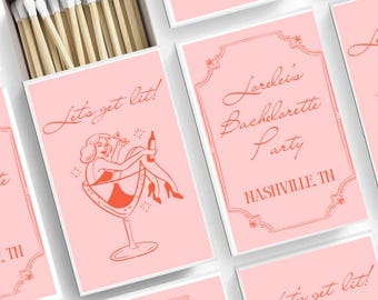 May include: Pink matchboxes with a red illustration of a woman sitting in a martini glass. The text "Let's get lit!" is printed on the front of the matchbox. The text "Lorelei's Bachelorette Party Nashville, TN" is printed on a separate matchbox.