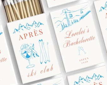 May include: A white matchbox with a blue and red illustration of a woman skiing. The text "APRÈS ski club" is printed in red on the box. The matchbox is filled with wooden matches with white tips.