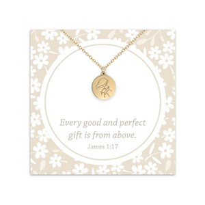 May include: Gold necklace with a round pendant featuring a hand-drawn image of two hands clasped together. The card reads "Every good and perfect gift is from above. James 1:17".