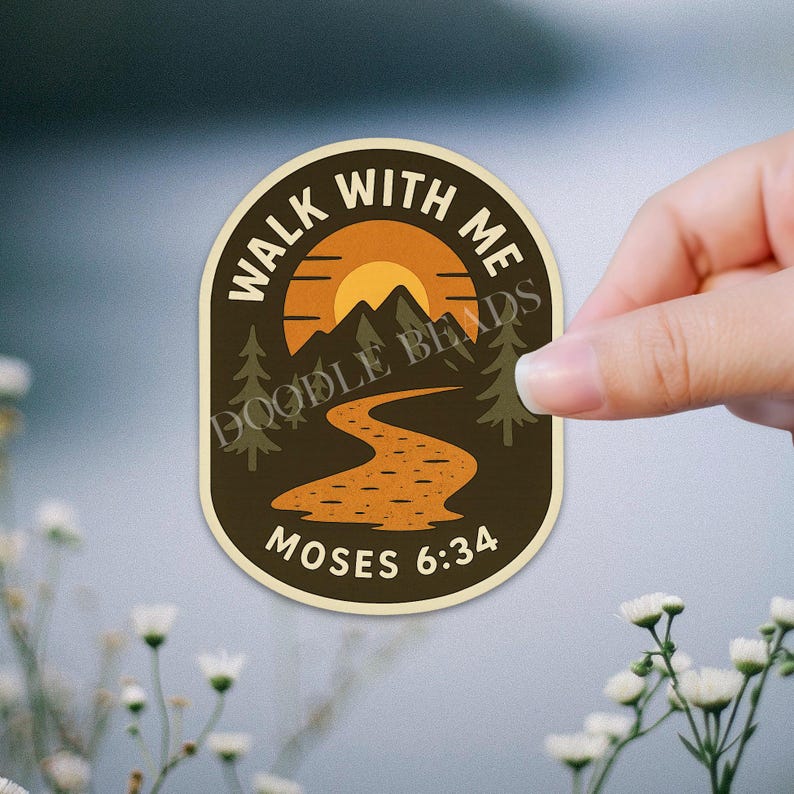 May include: An oval sticker with a nature scene, featuring a sunset over mountains and a winding path. The text "WALK WITH ME" arches across the top, with "MOSES 6:34" at the bottom. The sticker is held by a hand.
