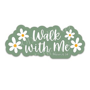 May include: A sticker with a sage green background and white text that reads "Walk with Me" with the reference "Moses 6:34". The sticker is decorated with white daisies with yellow centers.