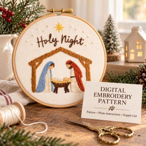 May include: A circular wooden embroidery hoop containing white fabric with a hand-stitched nativity scene featuring the text Holy Night and a yellow star. A white card reads DIGITAL EMBROIDERY PATTERN, Pattern, Photo Instructions, Supply List.