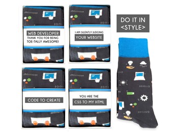 May include: Four white boxes with black and white illustrations of a computer screen and hands typing on a keyboard. The boxes have text that reads "Web Developer Thank You for Being Toe-Tally Awesome!" "I Am Silently Judging Your Website" "Code to Create" and "You Are the CSS to My HTML". A single black sock with a blue cuff and a pattern of computer-related icons. The sock has the text "Do It In <Style>" on a white tag.