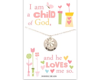 May include: A silver necklace with a flower charm that says "he loves me". The necklace comes on a card with a pink and green floral design and the text "I am a child of God, and he LOVES me so. Doodle Beads".