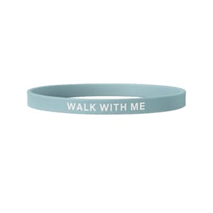 May include: A light blue silicone wristband with the phrase "WALK WITH ME" printed in white. The band is a simple, circular design, suitable for everyday wear. The wristband is approximately 8 inches in circumference.