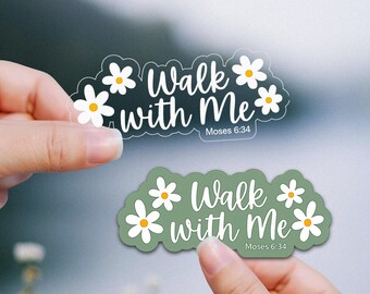 May include: Two die-cut stickers featuring white daisy illustrations and the text Walk with Me Moses 6:34 in white script. One sticker is transparent with white text, and the other has a solid sage green background with white text.