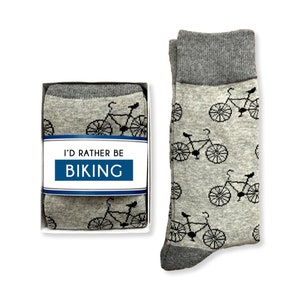 May include: A pair of gray socks with a black bicycle pattern. The socks come in a box with the text "I'd Rather Be Biking".