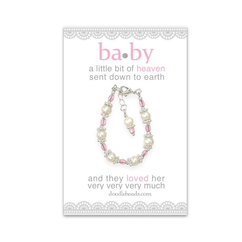 May include: A white and pink beaded bracelet with a silver clasp. The card reads "ba.by a little bit of heaven sent down to earth and they loved her very very very much doodlebeads.com"